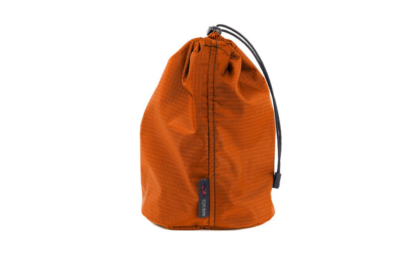 A Size 3 Persimmon (dark orange with orange grid) 210 Cerylon Travel Stuff Sack.